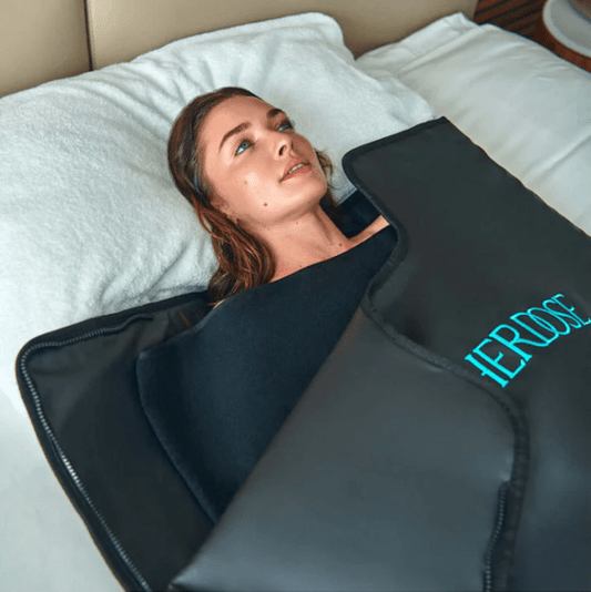 HigherDose Sauna Blanket and Insert Bundle Woman on Bed